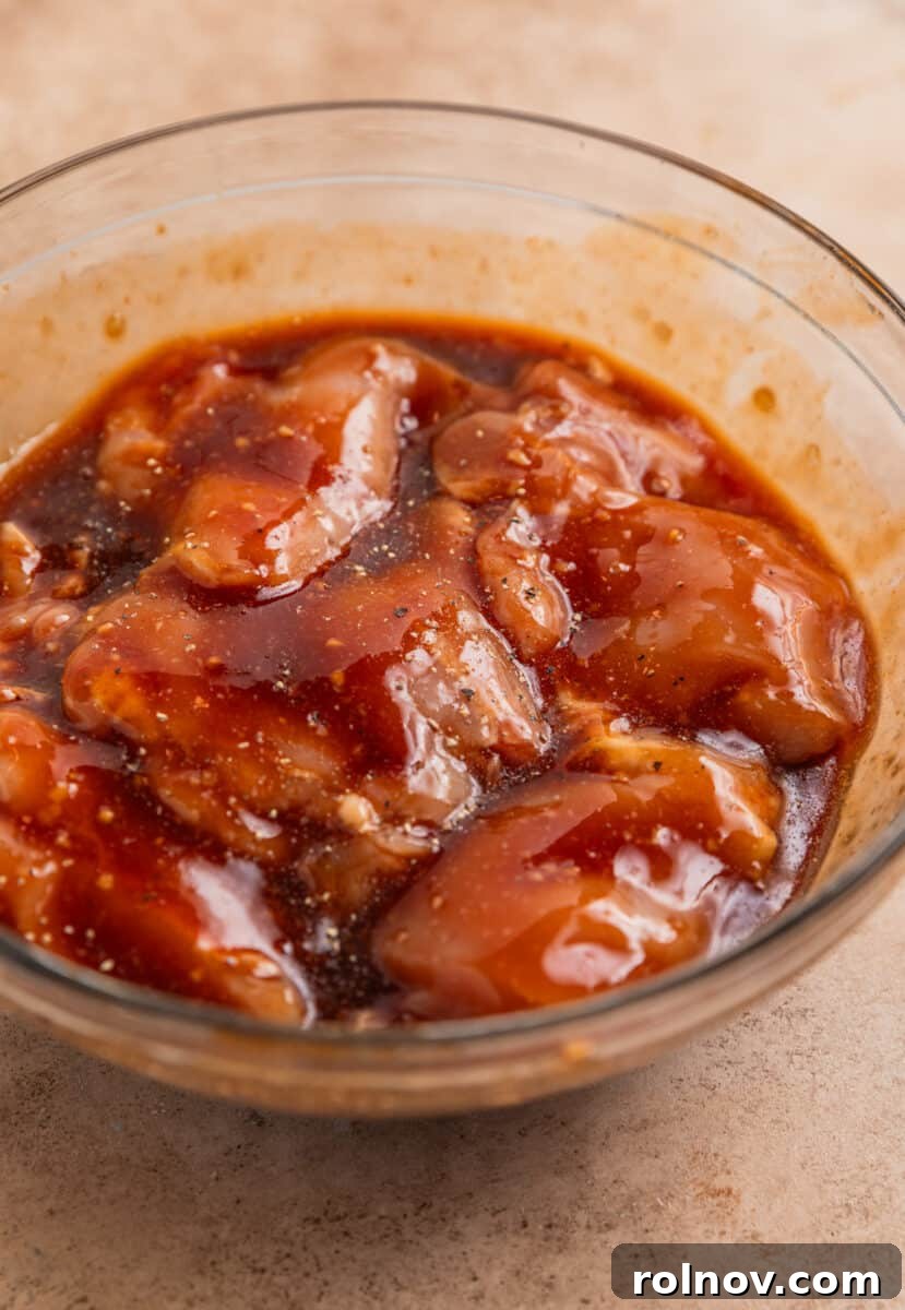 One-Pan Honey Garlic Chicken Thigh Dinner 5 Chicken thighs marinating in honey garlic sauce.