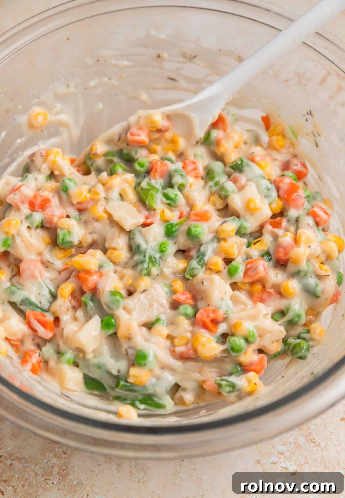 Hearty Beef Pot Pie 5 The creamy, colorful pot pie vegetable mixture in a bowl, stirred and perfectly seasoned, waiting for the beef.