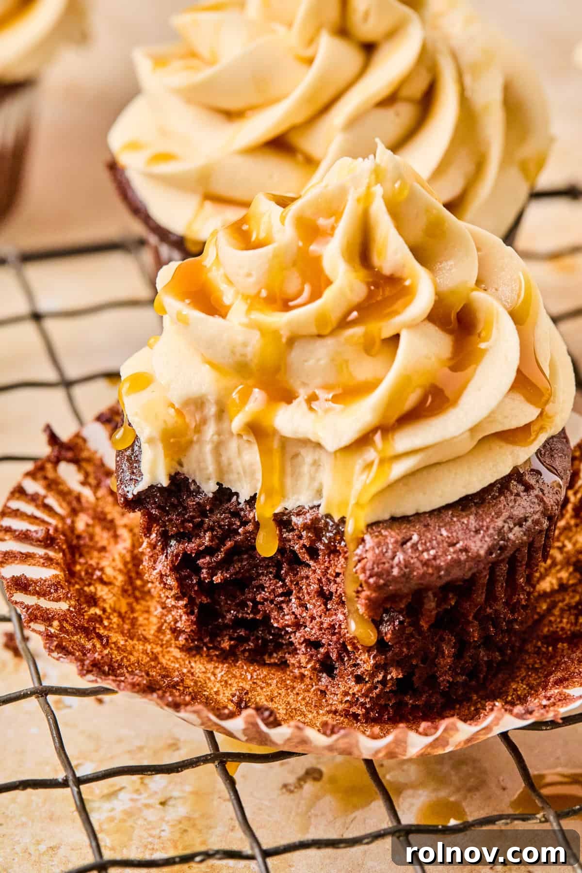 Salted Caramel Mocha Dream Cupcakes 4 A half-eaten Mocha Cupcake with a rich chocolate base and creamy salted caramel frosting, showing its moist texture and delicious layers.