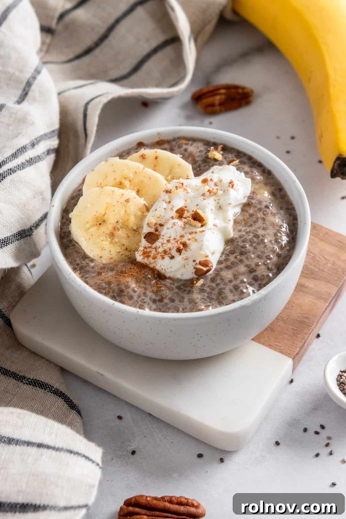Wholesome Banana Chia Seed Pudding 2 Banana chia seed pudding in bowl with dollop of yogurt, banana slices and cinnamon on top.
