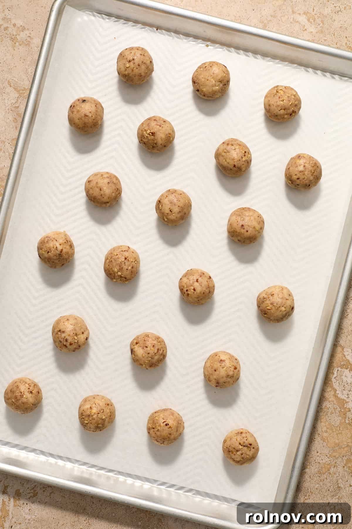 Velvety Pecan Cream Cheese Snowflakes 11 Christmas snowball cookie dough balls on parchment lined cookie sheet.
