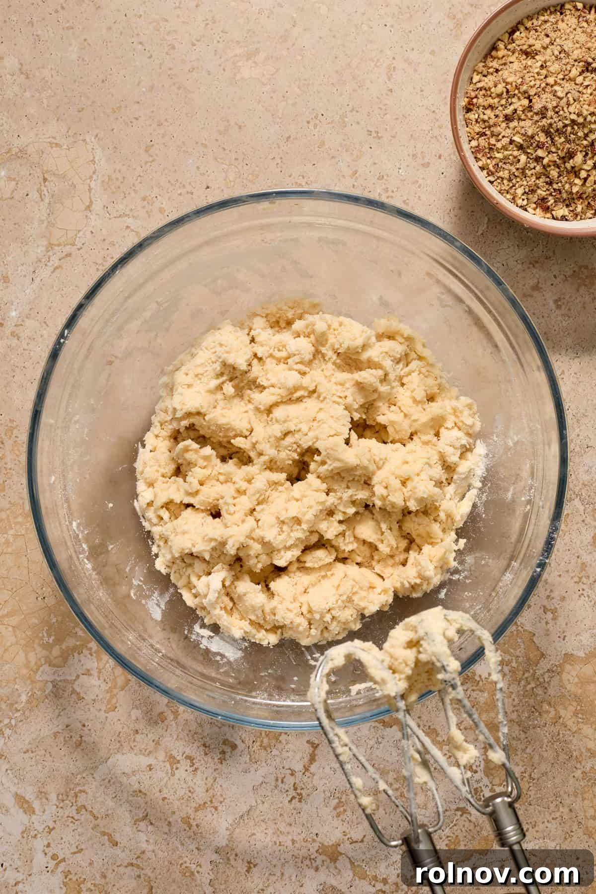 Velvety Pecan Cream Cheese Snowflakes 9 Flour added to cookie dough with hand mixer propped by the bowl.