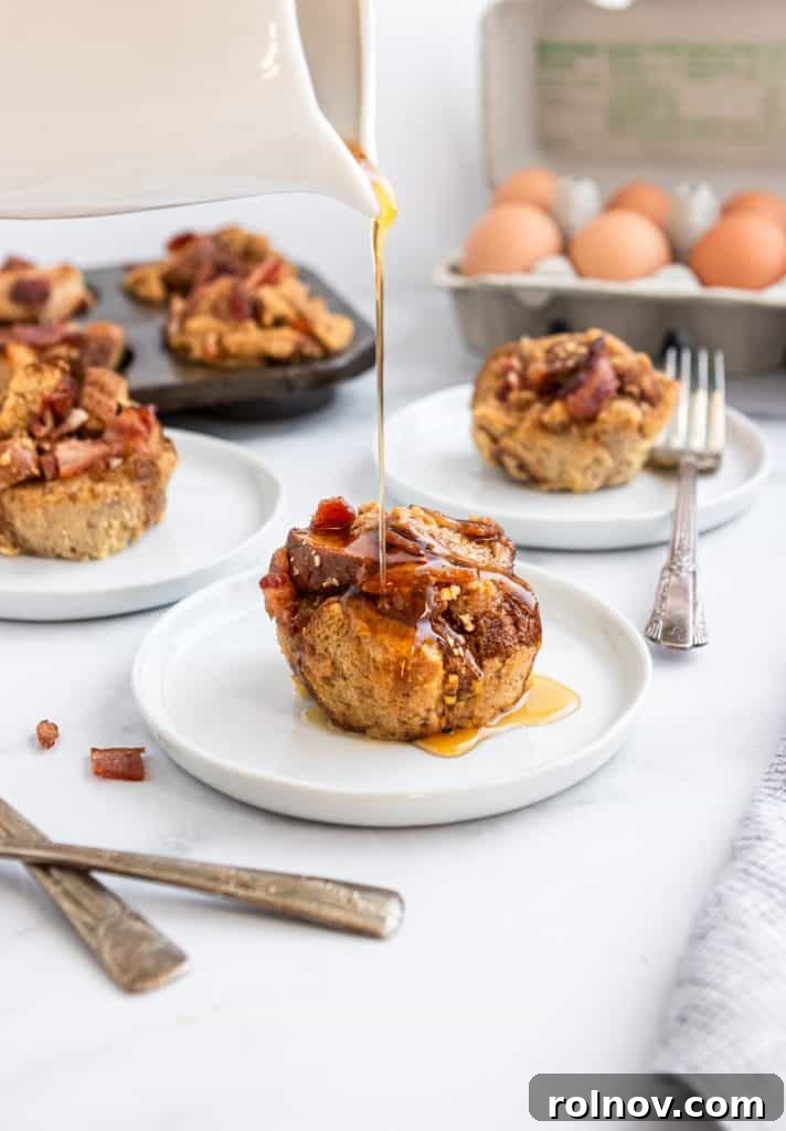 Golden maple syrup elegantly cascading over a warm Maple Bacon French Toast Muffin, showcasing its irresistible texture and glistening appeal.