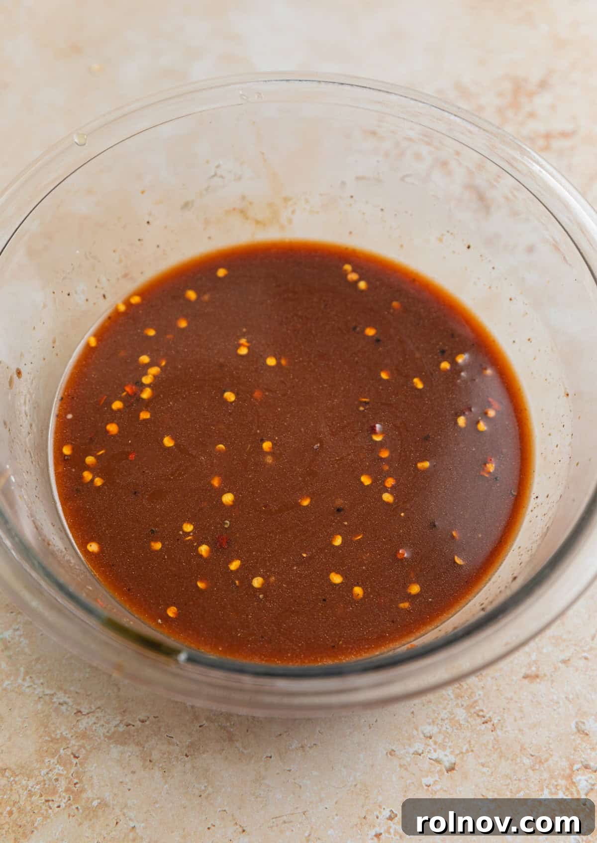 Golden Baked Cashew Chicken 5 Cashew chicken sauce prepared in glass mixing bowl.
