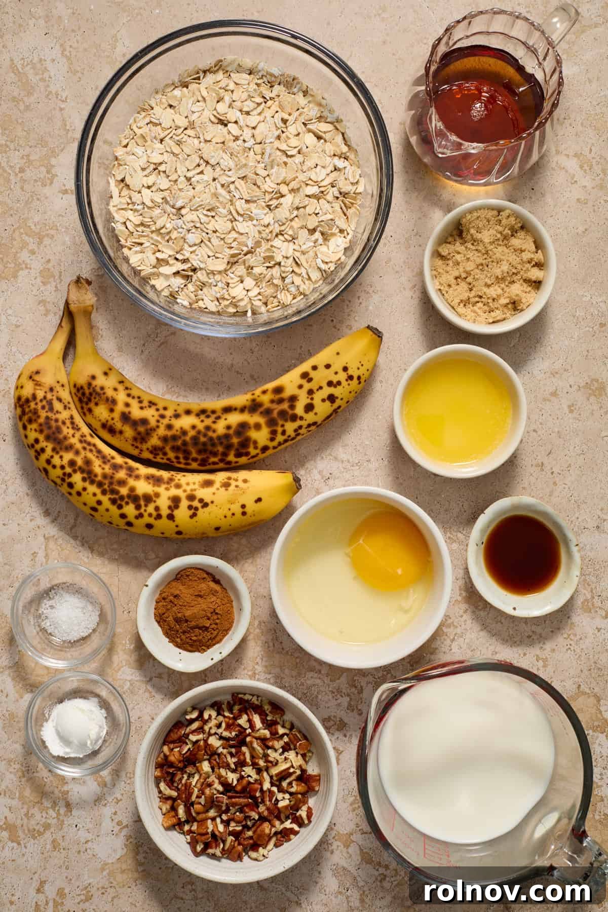 Ultimate Banana Bread Baked Oatmeal 3 Collection of ripe brown bananas, a single egg, melted butter, and other key ingredients neatly arranged on a counter, ready for mixing.