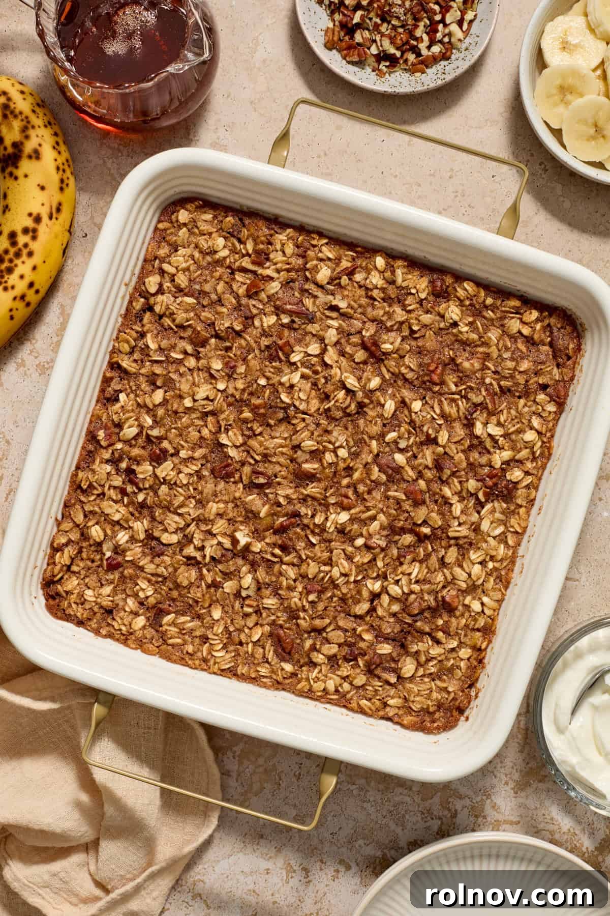 Ultimate Banana Bread Baked Oatmeal 4 A freshly baked pan of golden-brown Banana Bread Baked Oatmeal, ready to be cooled and served.