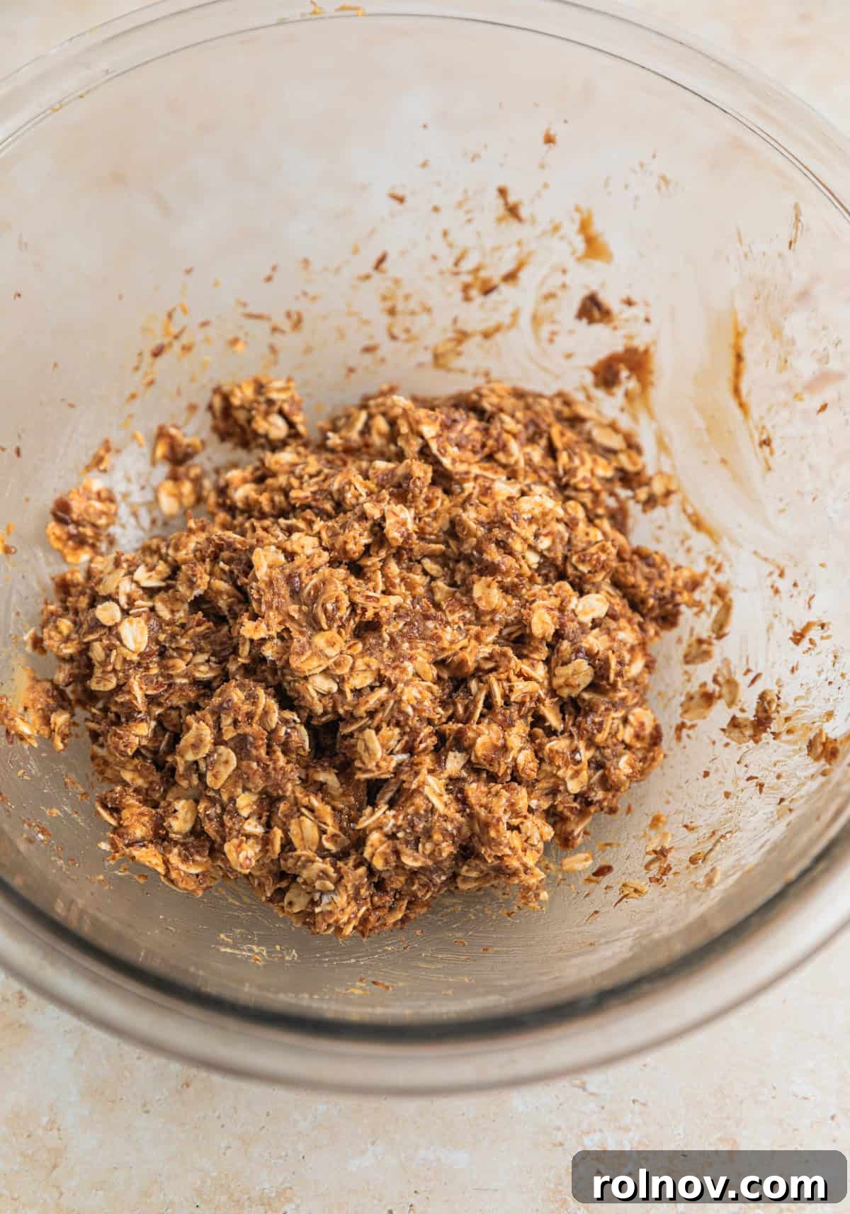 Peanut Butter Oatmeal Energy Bites 5 Close-up of the oat and peanut butter ball mixture in a glass bowl, showing its combined texture.