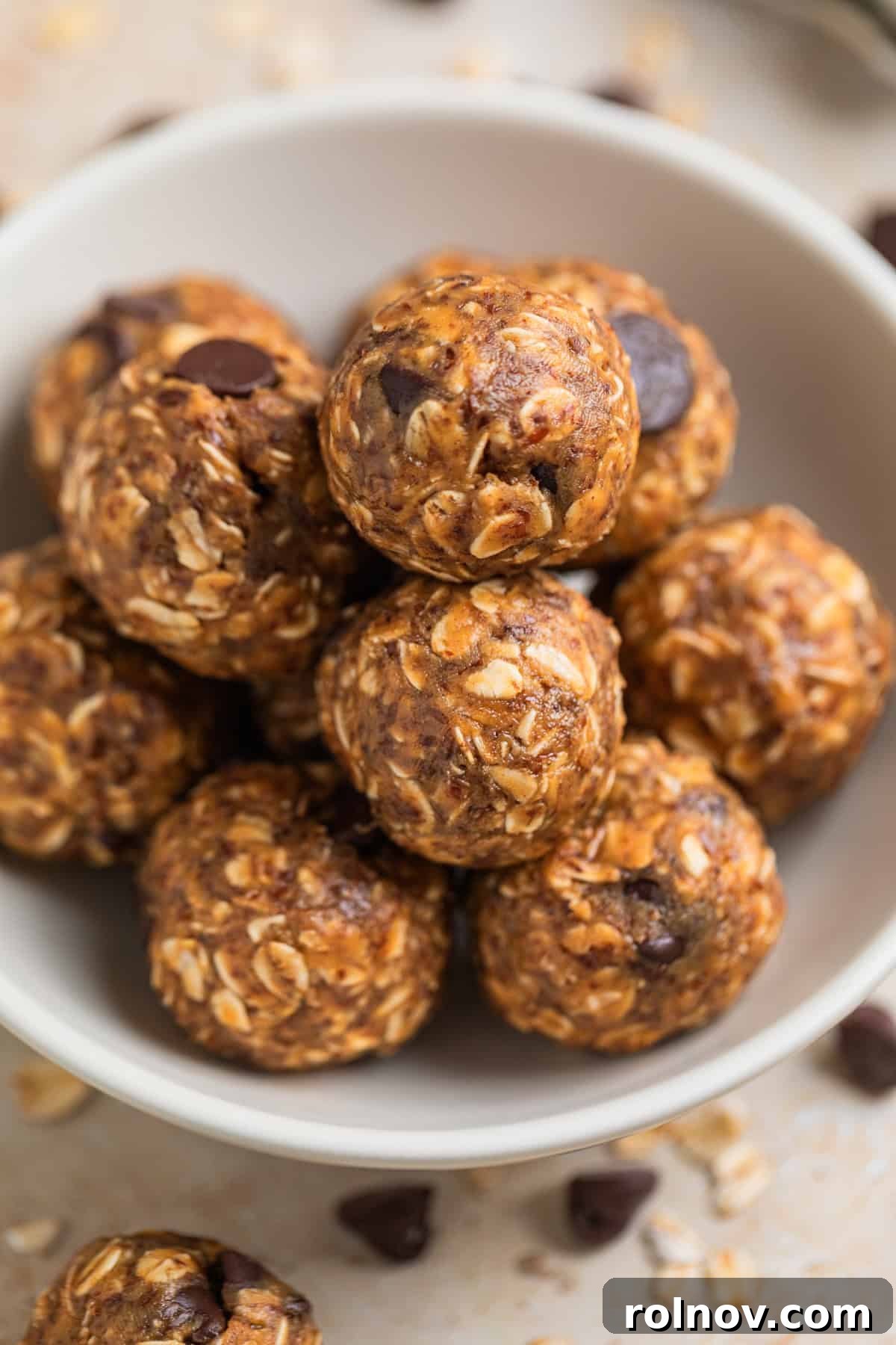 Peanut Butter Oatmeal Energy Bites 7 A close-up view of perfectly formed oat and peanut butter balls nestled in a white dish, ready to be served.