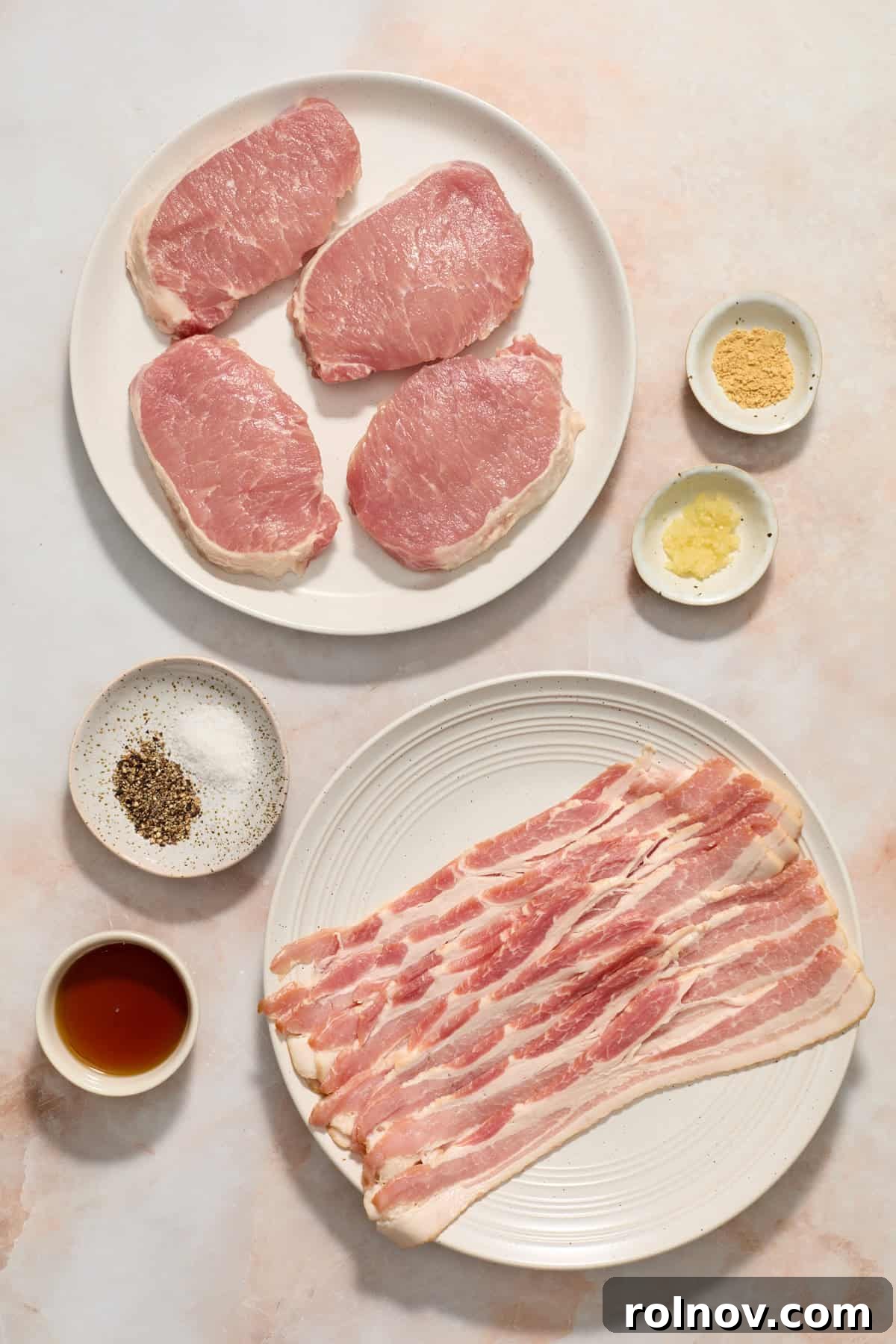 Sweet and Savory Maple Bacon Pork Chops 4 Pork chops, bacon strips, maple syrup, minced garlic, and ground mustard arranged neatly on a kitchen surface, ready for preparation.