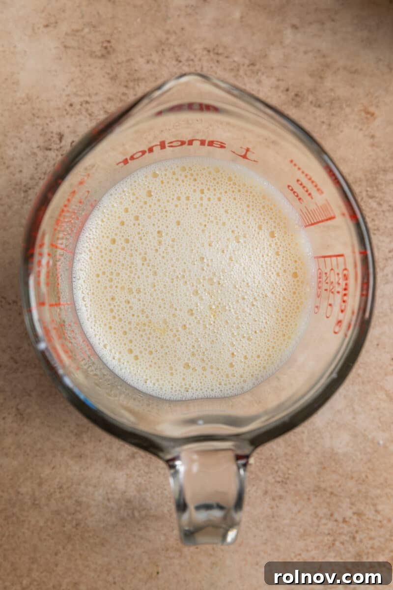 Golden Honey Biscuits 6 Honey and milk mixture in glass measuring cup.
