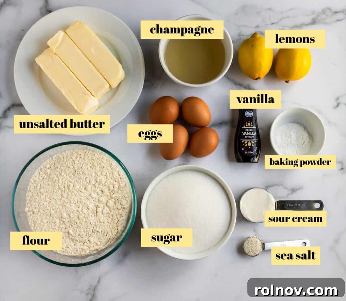 Effervescent Lemon Bundt Cake 4 A selection of key baking ingredients including flour, sugar, eggs, and fresh lemons, ready for preparation.