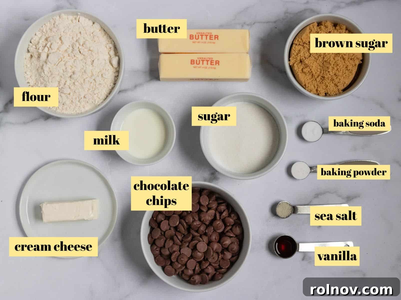 All the essential ingredients for baking eggless chocolate chip cookies laid out on a clean surface.