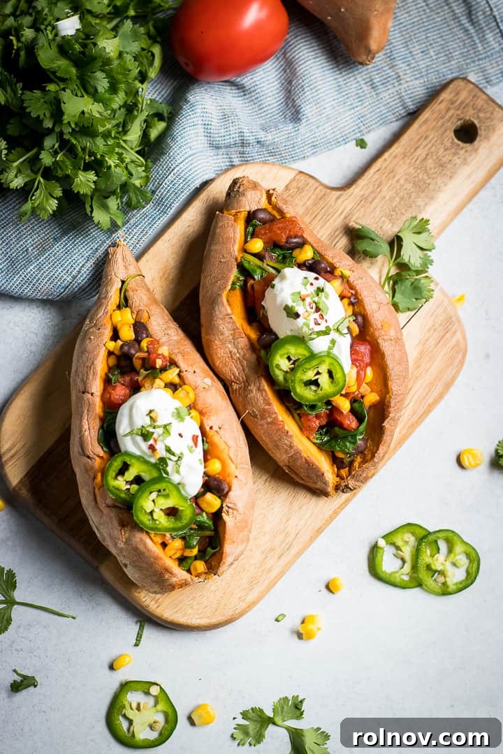 Fiesta Stuffed Sweet Potatoes 3 Mexican stuffed sweet potatoes with sour cream and jalapeno on top.