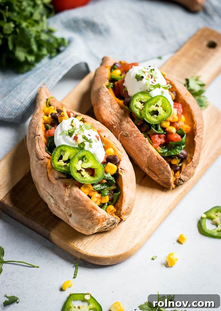 Fiesta Stuffed Sweet Potatoes 4 stuffed sweet potatoes on board.