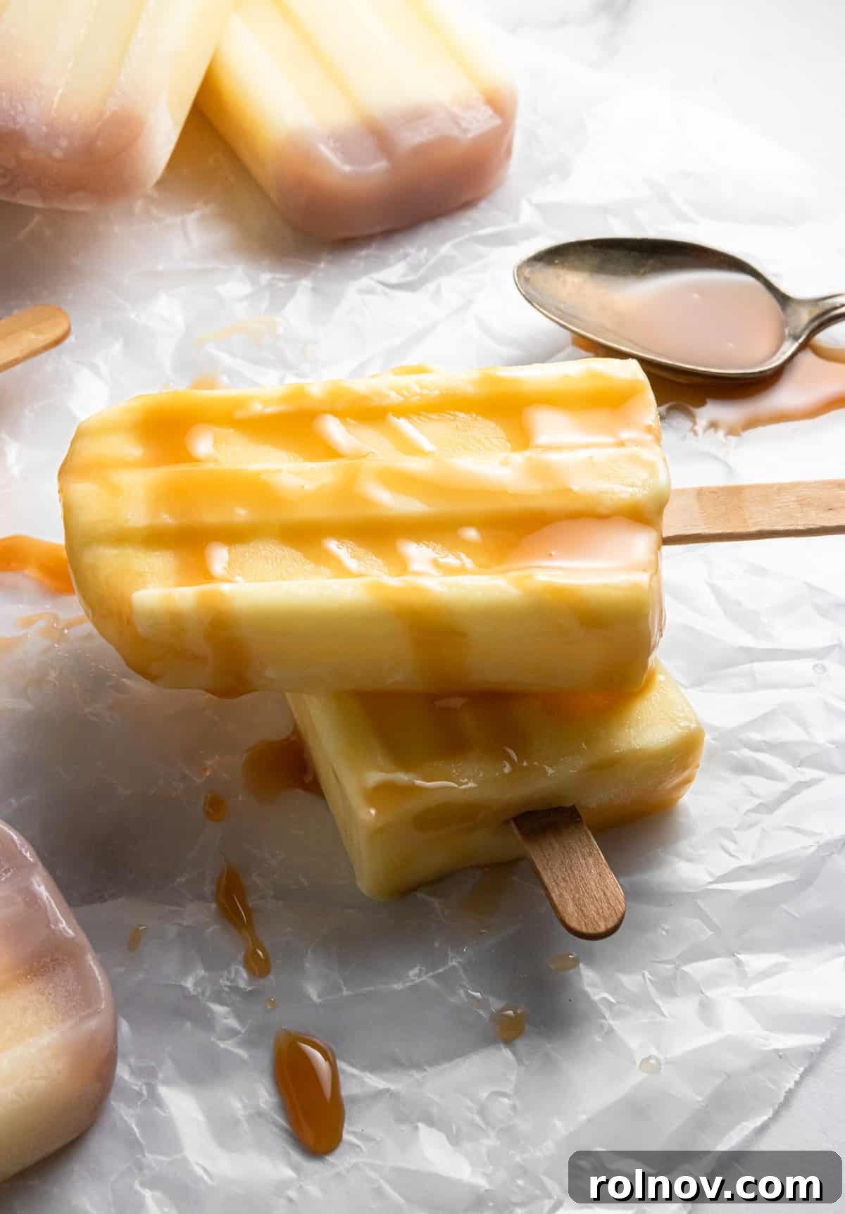 DIY Jello Pudding Pops 2 A stack of creamy homemade Jello Pudding Pops with a luxurious caramel drizzle.
