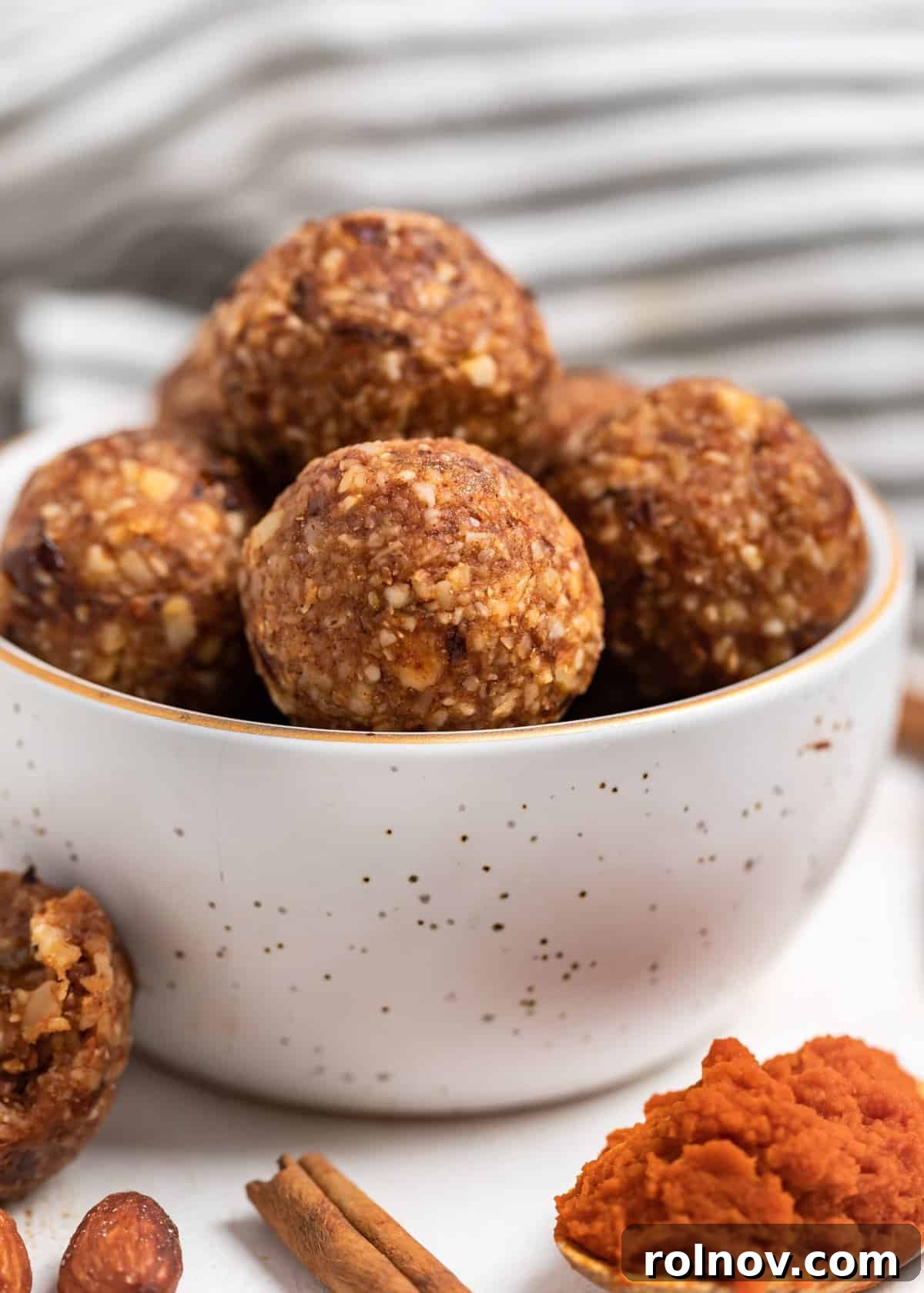 Pumpkin Spice Power Bites 4 A charming bowl overflowing with homemade pumpkin energy bites, presented beautifully and ready to be enjoyed as a healthy and delicious fall snack option.