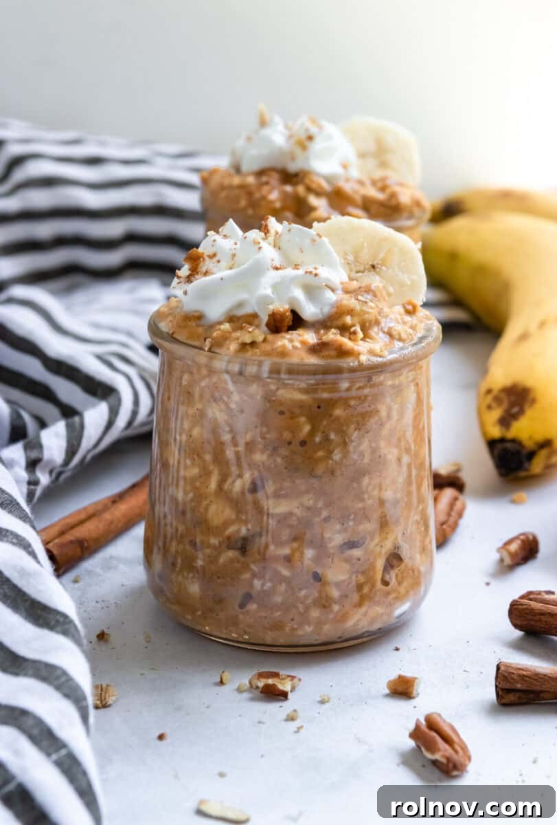 Golden Pumpkin Banana Overnight Oats 3 Jars of pumpkin banana overnight oats with banana, cinnamon sticks and pecans surrounding.