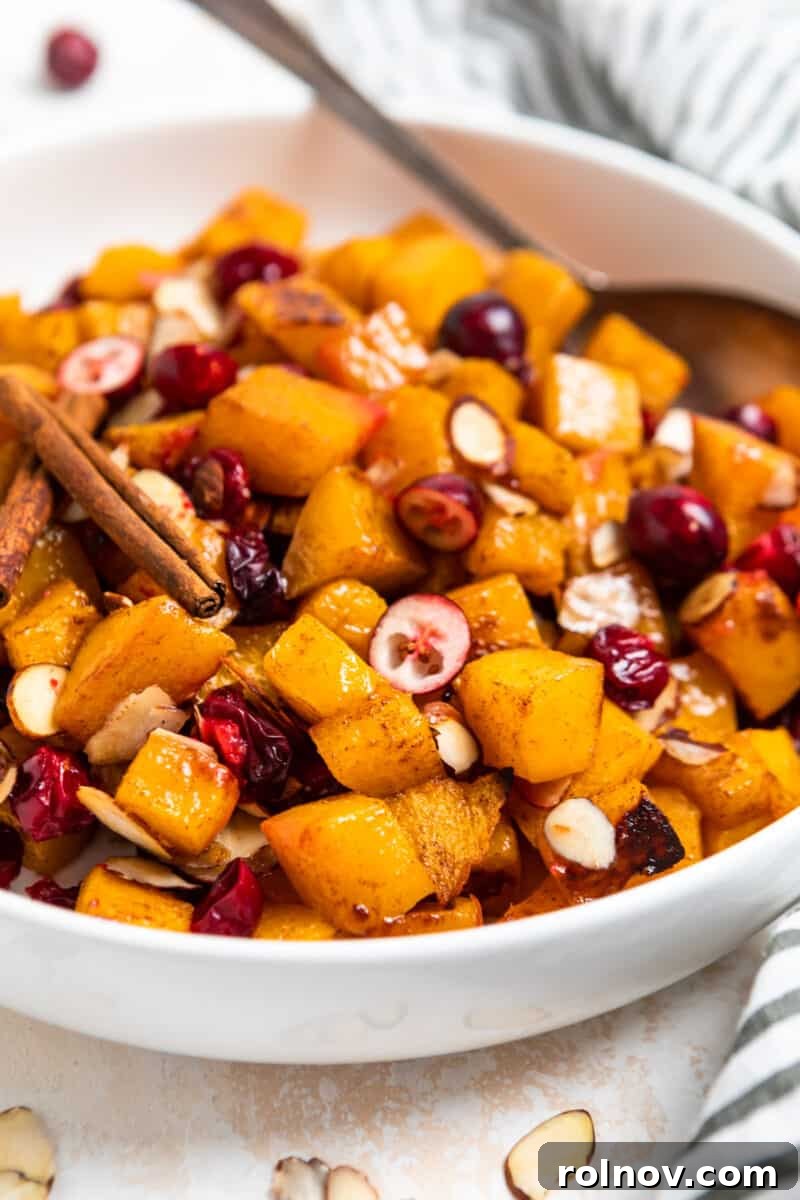 Golden Roasted Butternut Squash with Tart Cranberries and Toasted Almonds 2 A vibrant bowl of roasted butternut squash with almonds and cranberries, ready to be served as a cozy fall side dish.