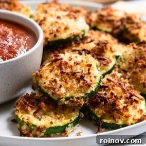 Crispy zucchini with cheese coating on a plate, ready to be served.