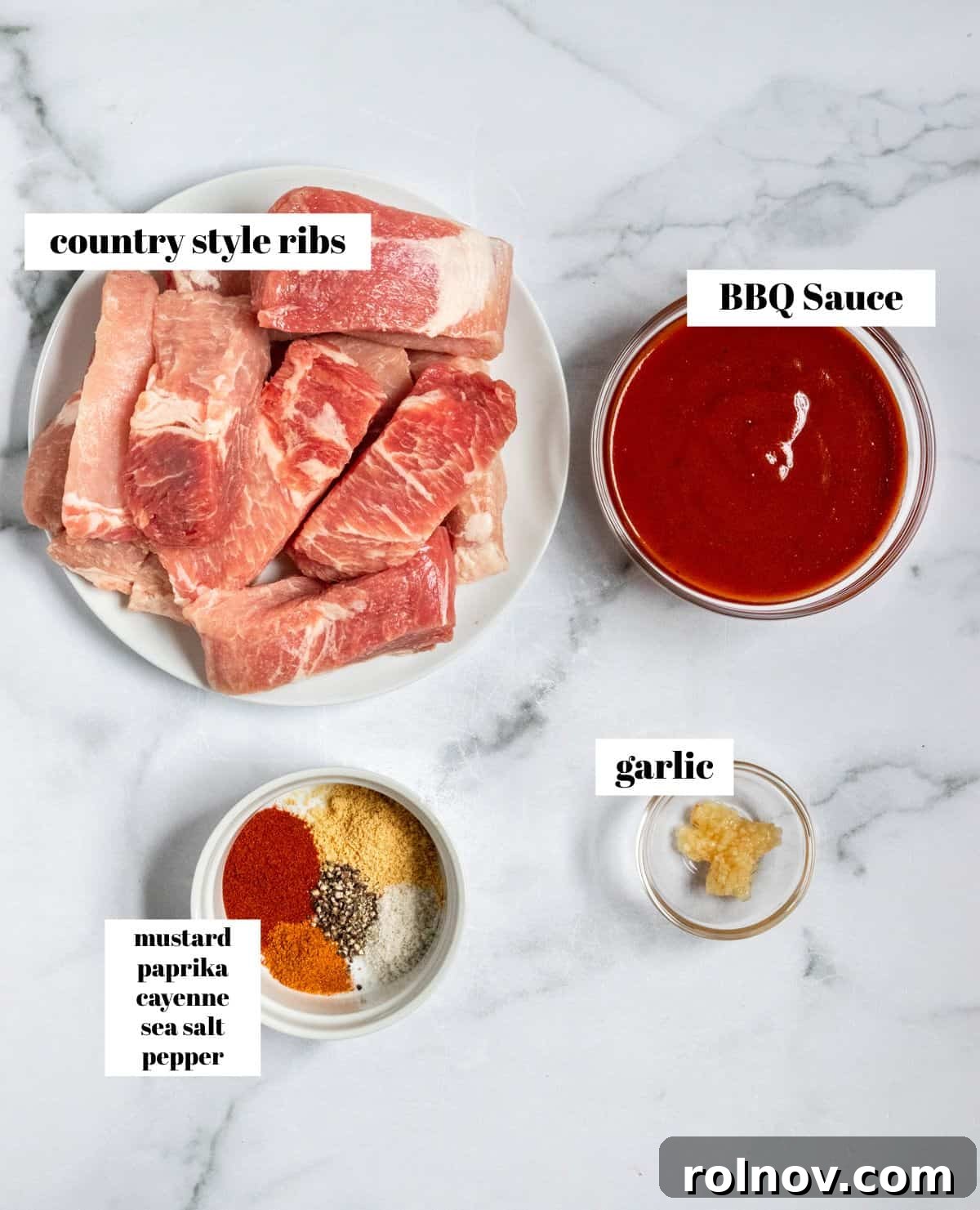 Slow Cooker BBQ Country Style Ribs 4 Raw country style boneless pork ribs, barbecue sauce, minced garlic, and various spices laid out on a kitchen counter, clearly labeled for preparation.