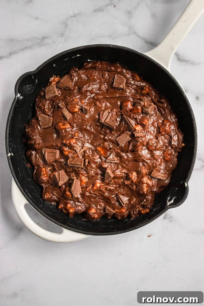 Gooey S'mores Skillet Brownie 6 Unbaked brownie batter in a cast iron skillet, ready for the oven.