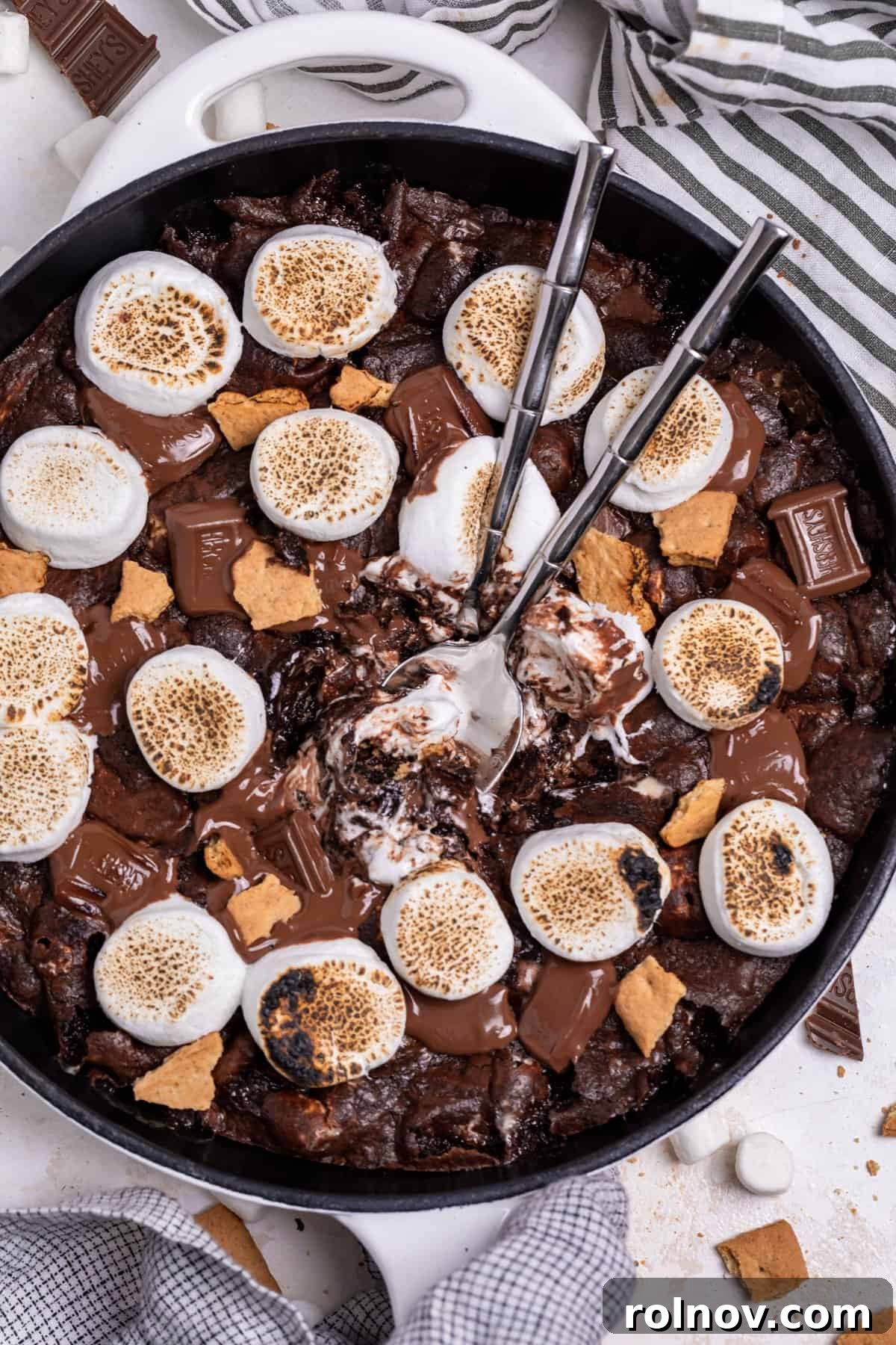 Gooey S'mores Skillet Brownie 8 Overhead shot of a S'mores Brownie Skillet with two spoons digging in, showcasing the gooey interior.
