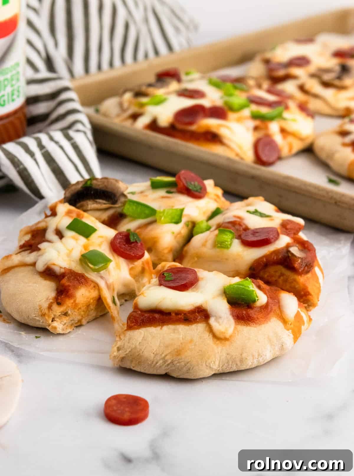 Stealthy Veggie Whole Wheat Pizza Bites 3 Pizza cut into fourths with pan in background.