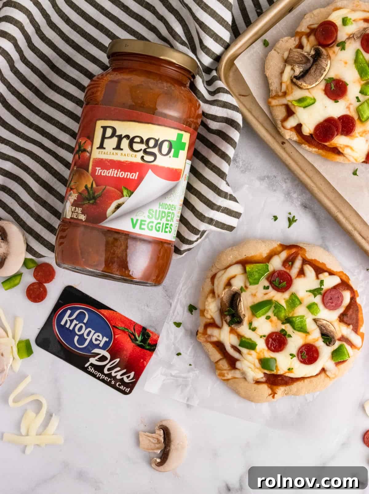 Stealthy Veggie Whole Wheat Pizza Bites 4 Prego and Kroger card with pizza on counter.