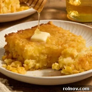 Golden Honey Cornbread Bake 13 Sweet jiffy cornbread casserole on plate with honey drizzling over top.