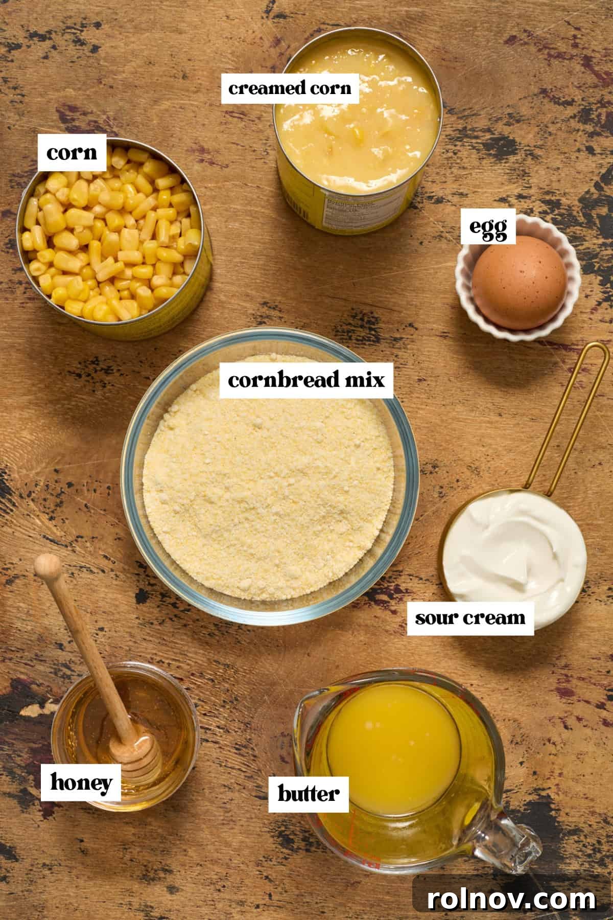 Golden Honey Cornbread Bake 4 Cornbread mix, honey, creamed corn and other ingredients arranged on surface.
