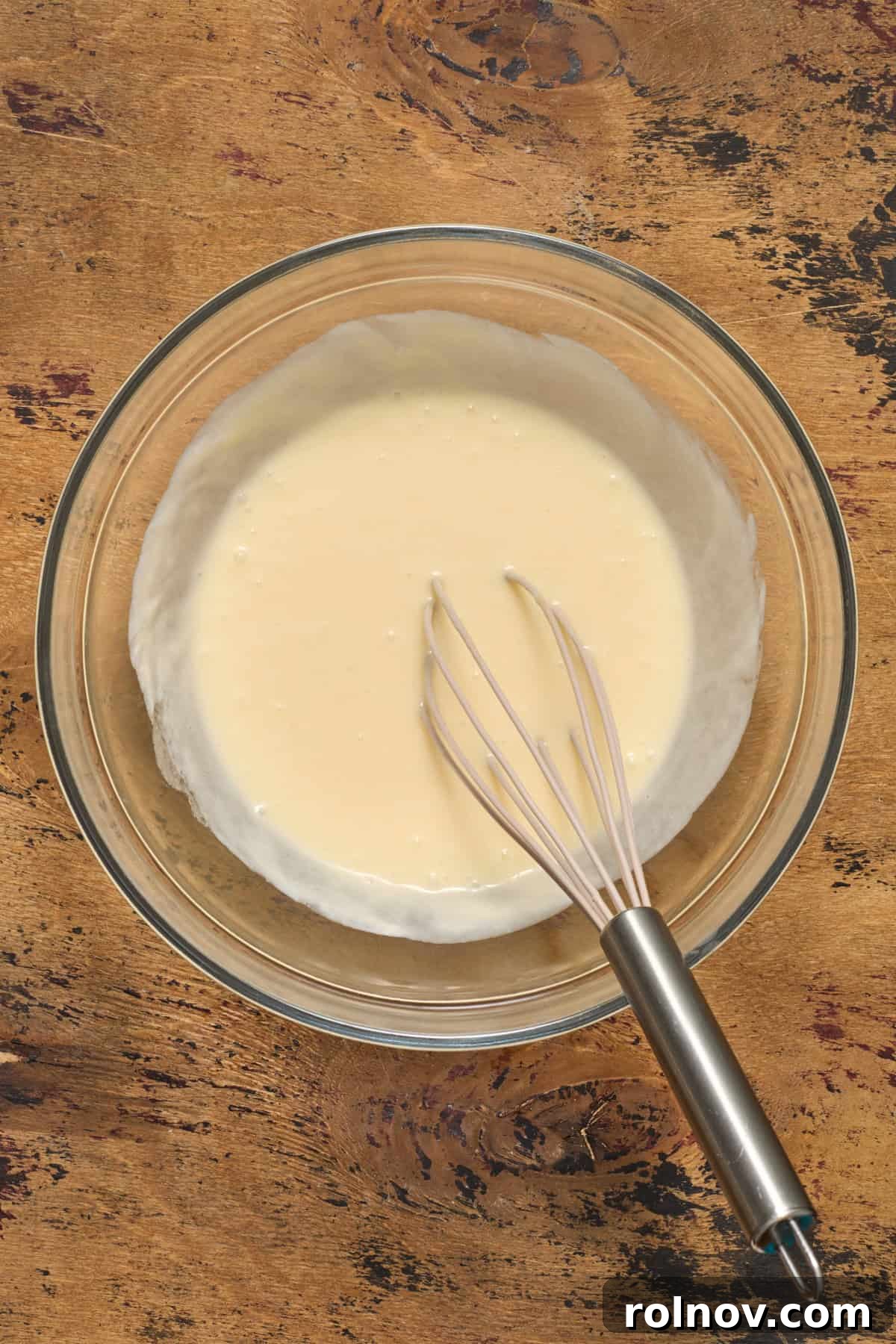 Golden Honey Cornbread Bake 6 Egg, honey, sour cream and butter whisked in glass bowl.
