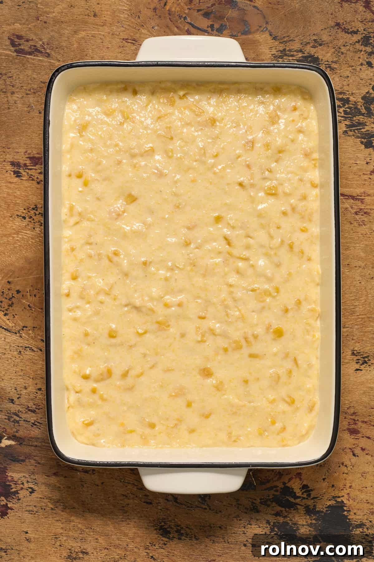 Golden Honey Cornbread Bake 9 Casserole dish with jiffy sweet cornbread casserole before baked.