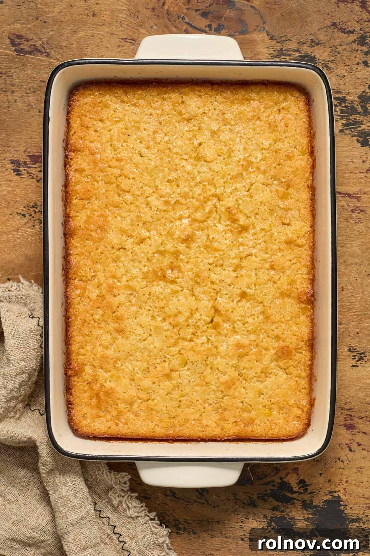 Golden Honey Cornbread Bake 10 Baked honey cornbread casserole in baking pan.