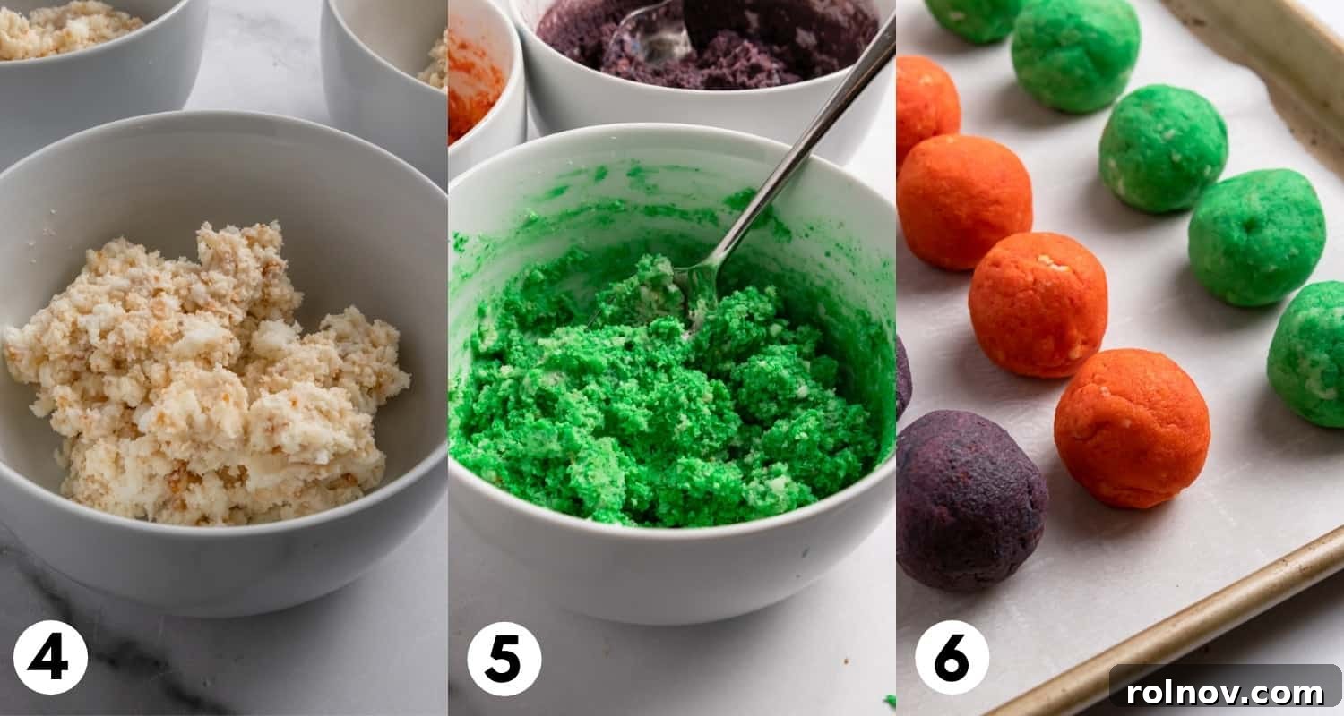 Perfectly dyed green, orange, and purple cake mixture rolled into uniform balls, neatly arranged on a baking pan lined with parchment paper.