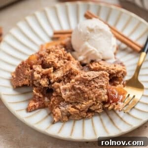 Effortless Golden Apple Bake 12 Finished Easy Apple Dump Cake served with a scoop of vanilla ice cream and cinnamon sticks, highlighting its delicious appeal.