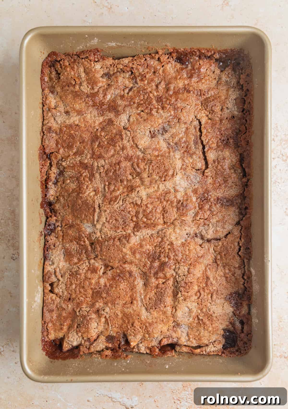 Effortless Golden Apple Bake 9 The baked apple dump cake, golden brown and bubbling, fresh out of the oven in its baking pan, showing the crisp topping and soft filling beneath.