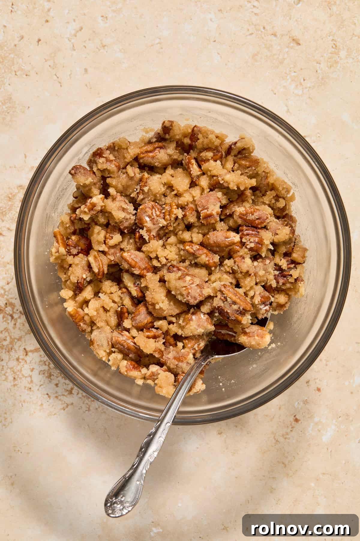 A bowl of the delicious pecan crumble topping, perfectly mixed and ready to adorn the casserole.