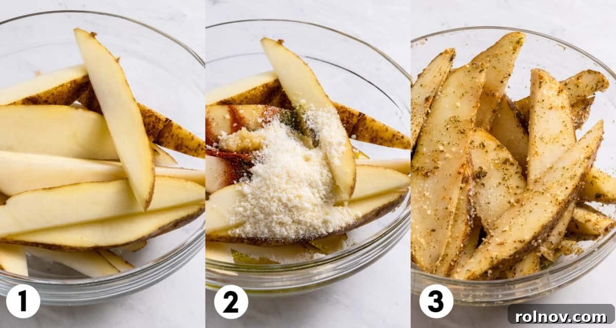 Potato wedges in a mixing bowl, generously coated with parmesan cheese and various seasonings, ready for the air fryer.