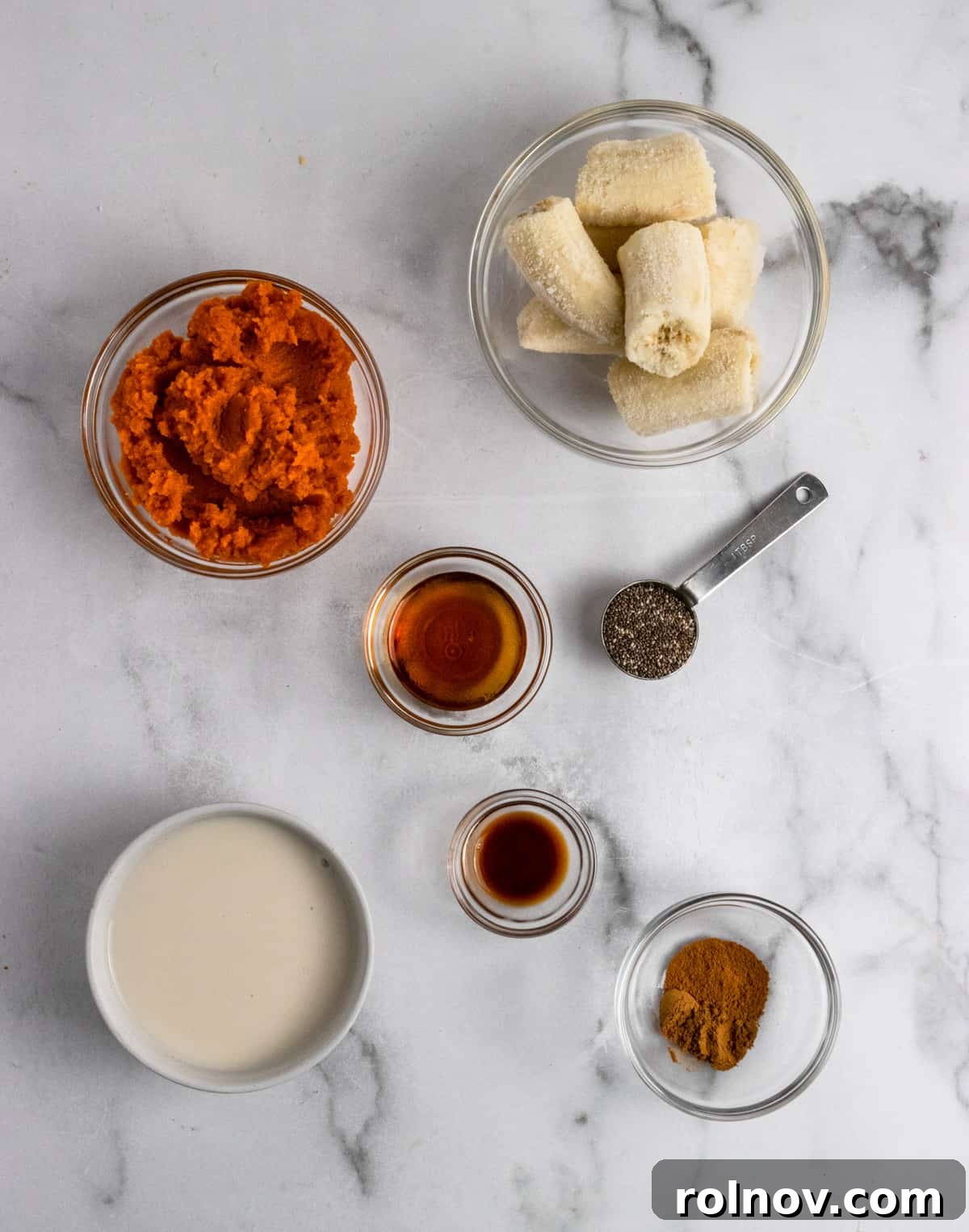 Spiced Pumpkin Pie Smoothie 4 All the fresh ingredients for a pumpkin pie smoothie laid out on a kitchen counter.