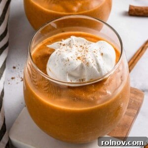 A refreshing Pumpkin Pie Smoothie served in a clear glass.