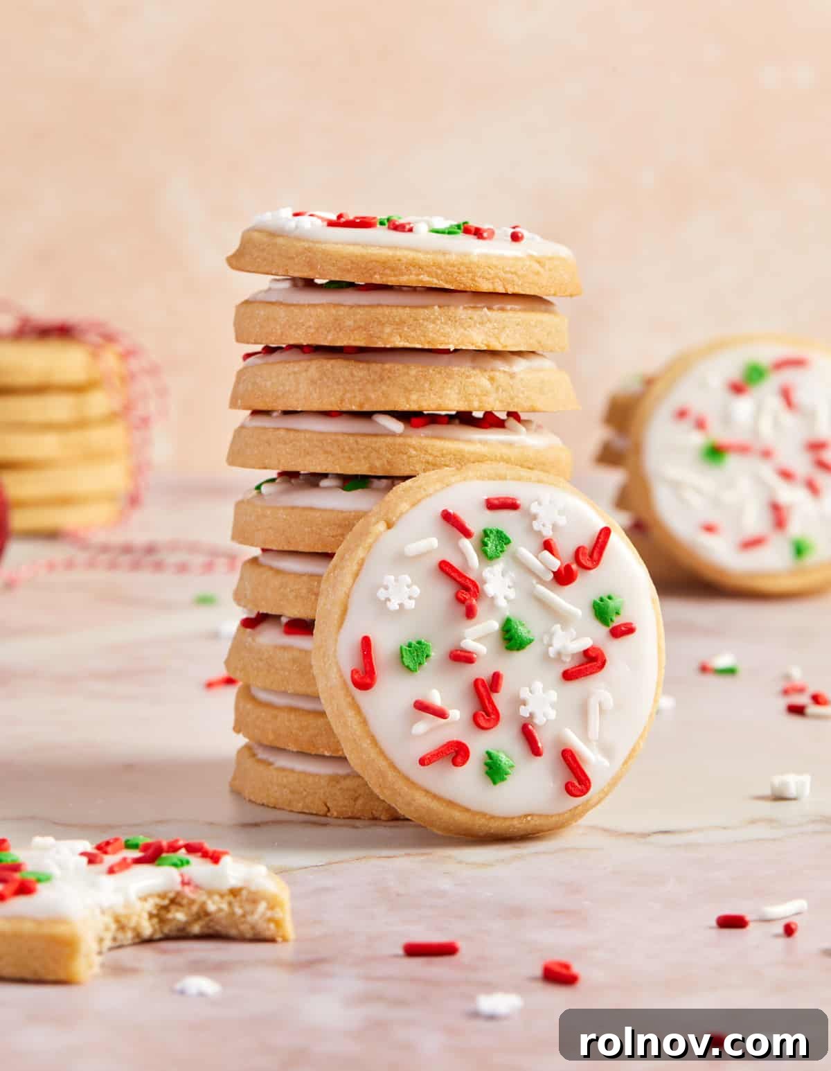 Buttery Holiday Shortbread Delights 13 Stack of iced brown sugar Christmas shortbread cookies with one cookie propped up against the stack.