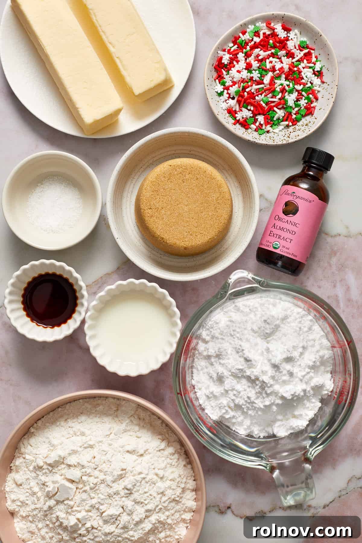 Buttery Holiday Shortbread Delights 4 Butter, brown sugar, almond extract, flour and other ingredients arranged on surface for recipe.