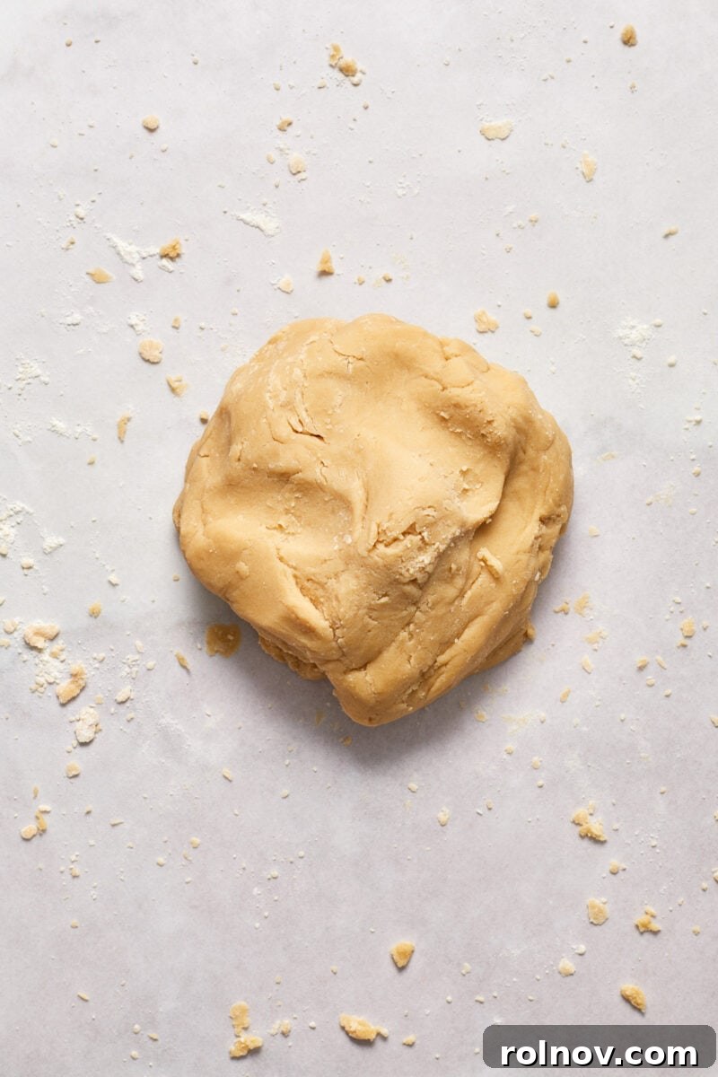 Buttery Holiday Shortbread Delights 7 Ball of cookie dough on floured surface.