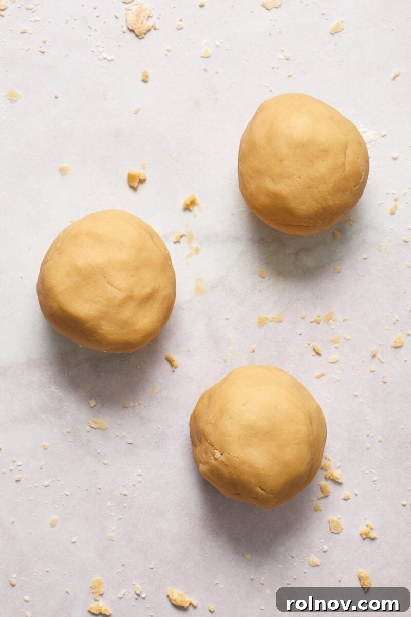 Buttery Holiday Shortbread Delights 8 3 smooth balls of brown sugar shortbread cookie dough on floured surface.