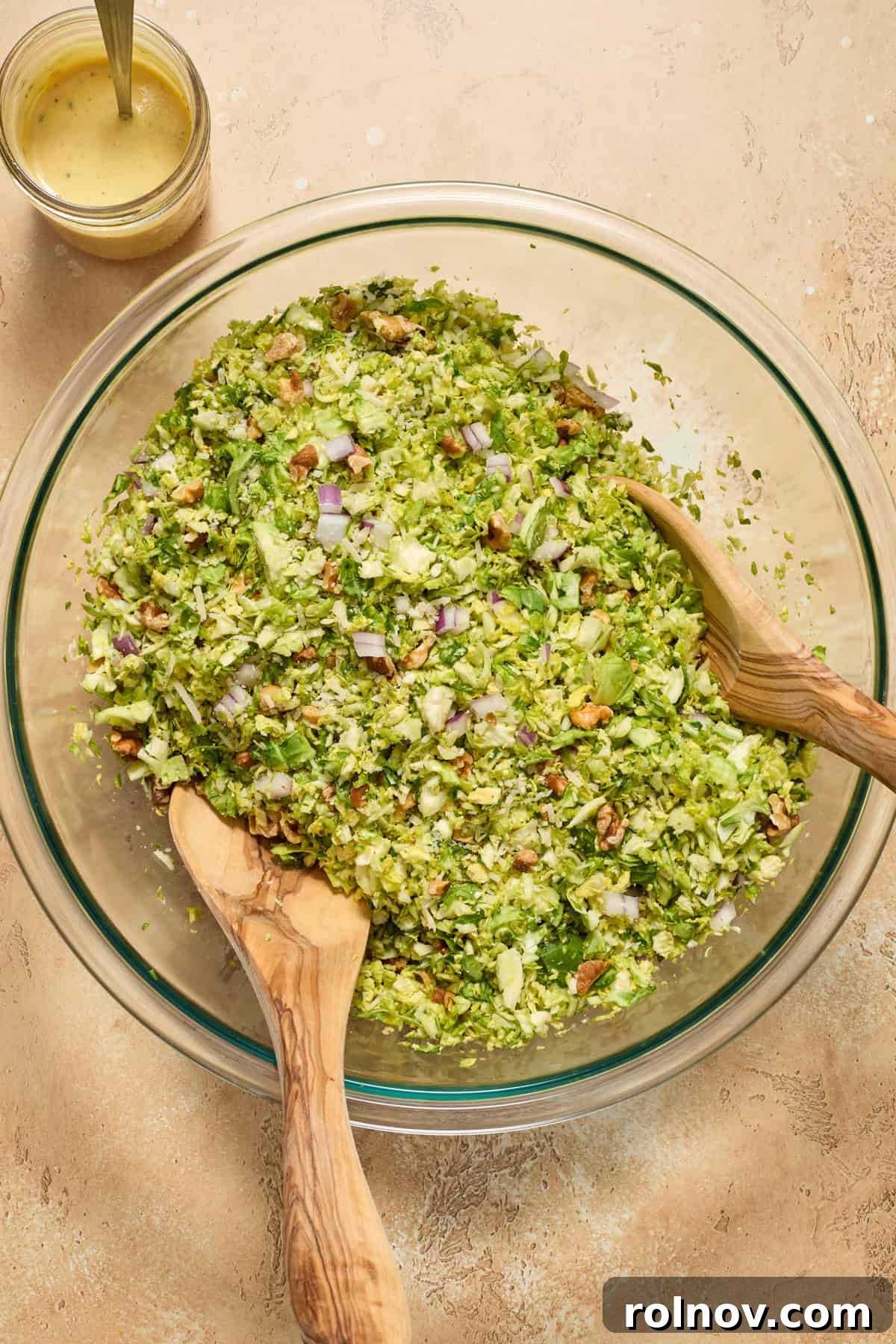 Zesty Brussels Sprout Slaw 7 Tossed Brussels sprouts, onion, walnuts and parmesan in salad bowl.