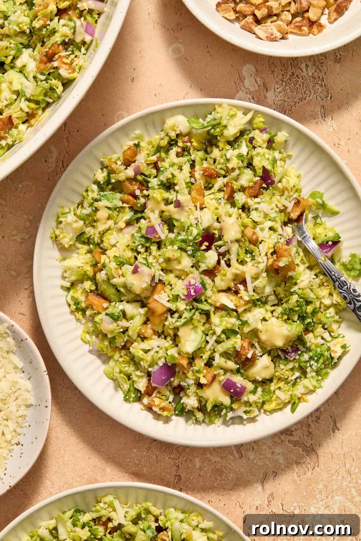Zesty Brussels Sprout Slaw 10 Plate with shaved brussels sprout salad with extra dijon dressing over top and fork scooping in.