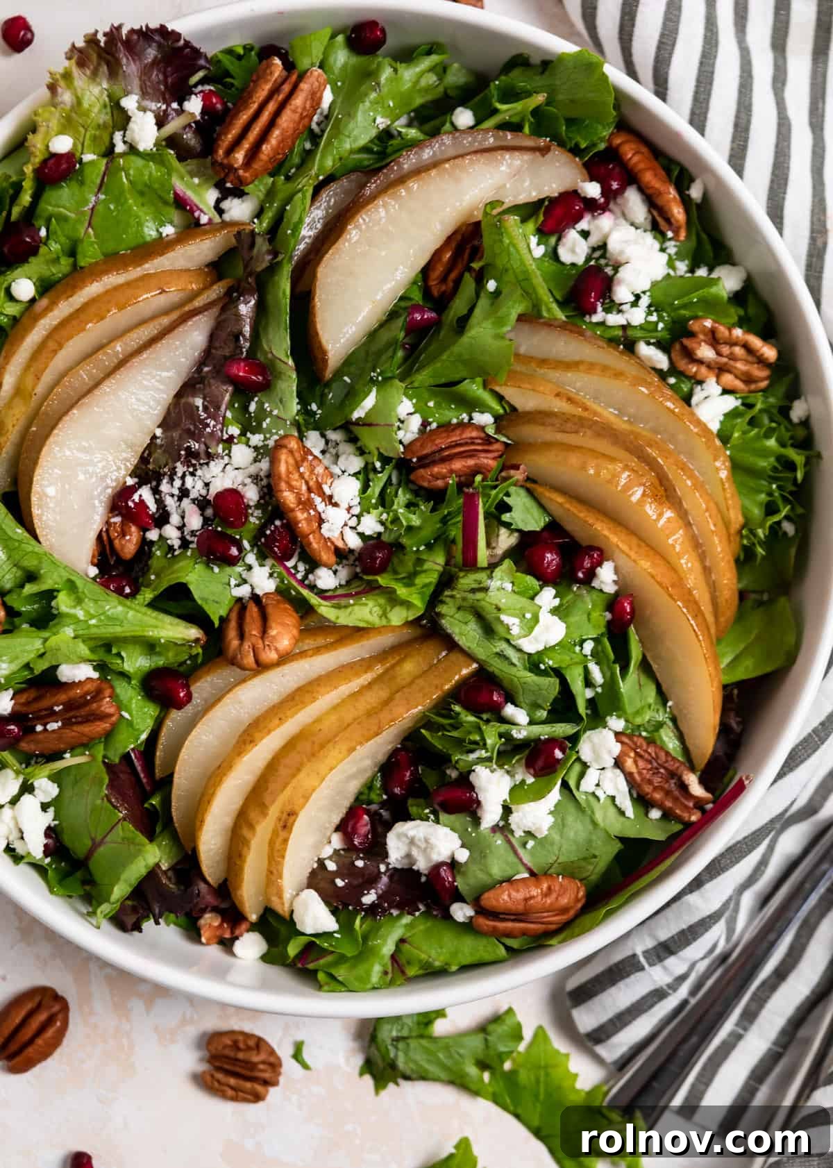 Golden Roasted Pear Salad 7 Overhead view of white bowl with pear salad.