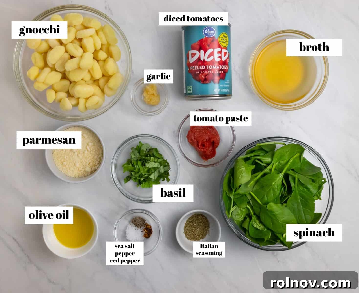 Quick and Easy 15 Minute Tomato Basil Gnocchi 3 Spinach, broth, Parmesan, and other ingredients labeled on a kitchen counter, ready for cooking.