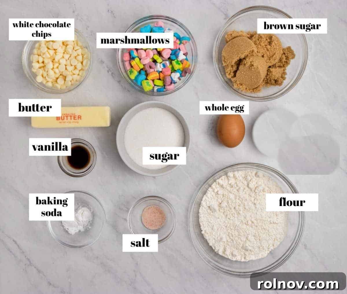 Charmed Bites 4 A collection of key ingredients, including butter, eggs, flour, white chocolate chips, and cereal marshmallows, meticulously laid out on a clean surface, ready for baking these magical Lucky Charm cookies.