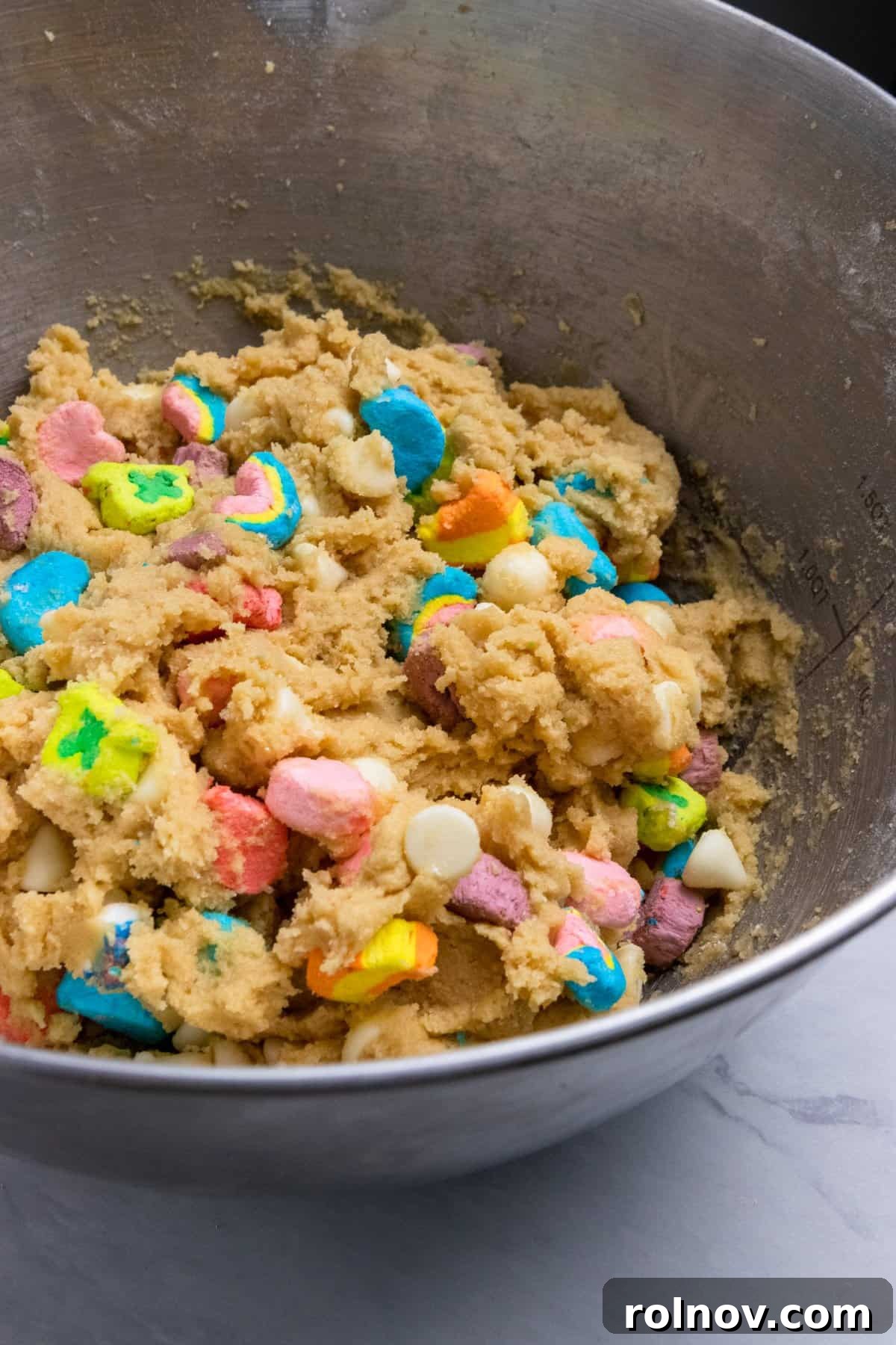 Charmed Bites 9 A close-up of the completed Lucky Charm cookie dough resting in the mixing bowl, showcasing its readiness for chilling or baking.
